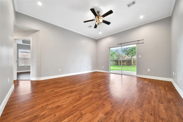 unfurnished room with visible vents, crown molding, baseboards, and wood-type flooring