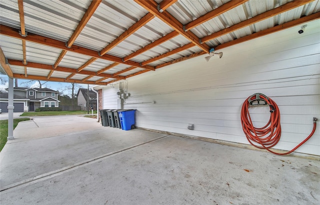 garage featuring a carport and concrete driveway