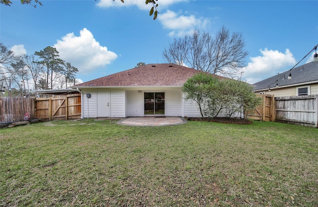 rear view of house with a yard, a patio, roof with shingles, and a fenced backyard