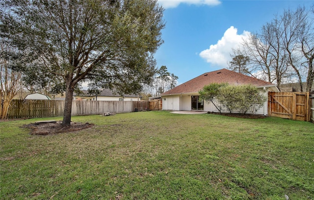 view of yard with a gate, a patio area, and a fenced backyard