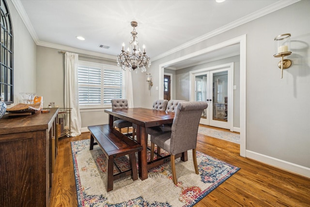 dining space with visible vents, baseboards, and wood finished floors