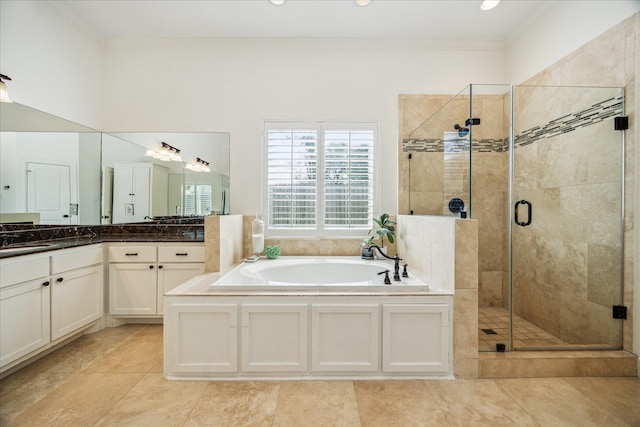 bathroom with tile patterned floors, a shower stall, crown molding, a bath, and vanity