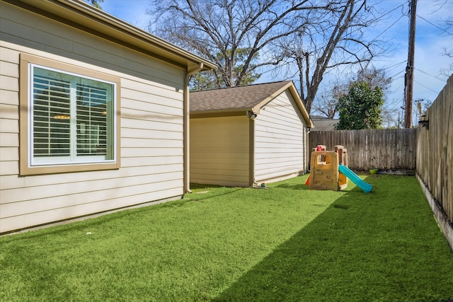 view of yard featuring a playground and a fenced backyard