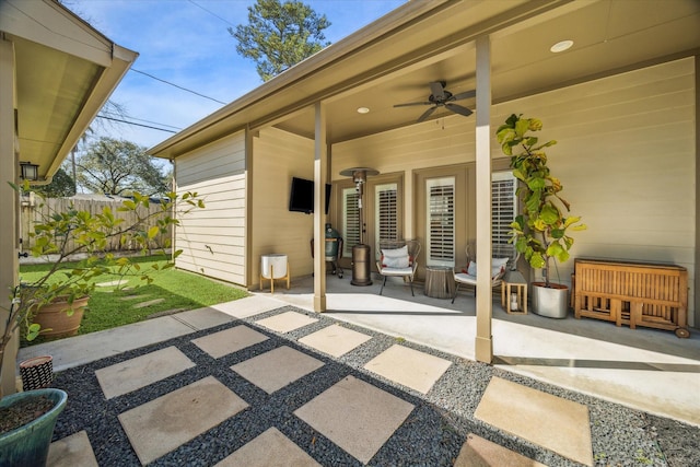 view of patio featuring ceiling fan and fence