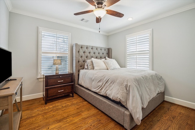 bedroom featuring visible vents, baseboards, and wood finished floors