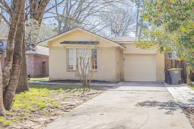 view of front of house with brick siding, concrete driveway, an attached garage, and fence