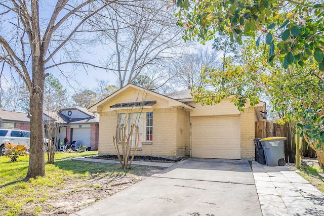 ranch-style house with concrete driveway, an attached garage, fence, and brick siding