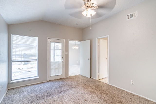 unfurnished room with light carpet, visible vents, a ceiling fan, and lofted ceiling