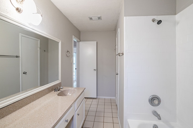 full bath with tile patterned floors, visible vents, a textured ceiling, washtub / shower combination, and vanity