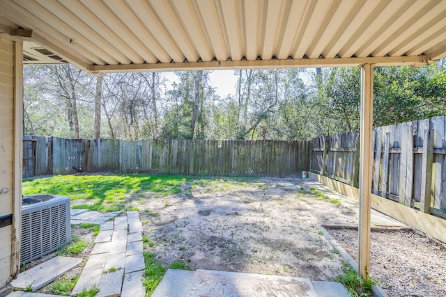 view of yard with central AC unit and a fenced backyard