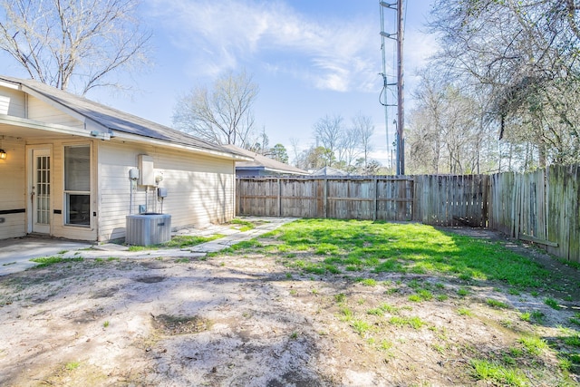 view of yard with cooling unit and a fenced backyard