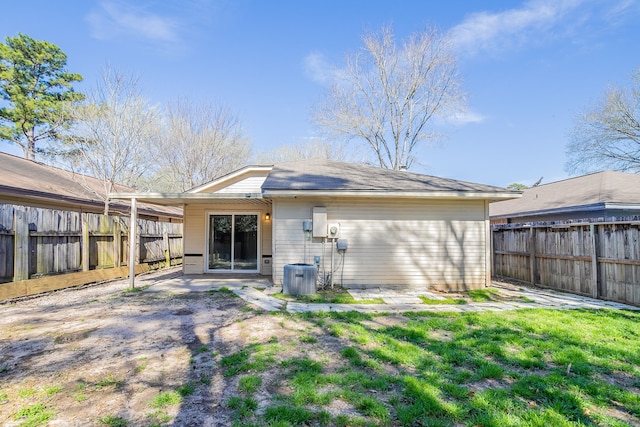 back of property with cooling unit and a fenced backyard