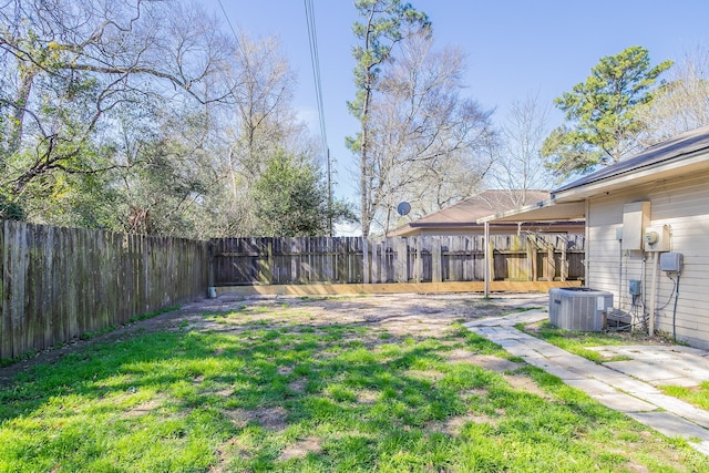 view of yard featuring a fenced backyard and central AC