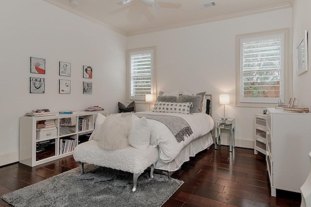 bedroom featuring baseboards, visible vents, dark wood finished floors, ceiling fan, and crown molding