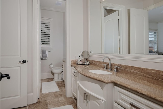 bathroom with vanity, baseboards, visible vents, crown molding, and toilet