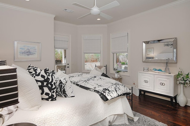 bedroom with ceiling fan, visible vents, dark wood finished floors, and crown molding