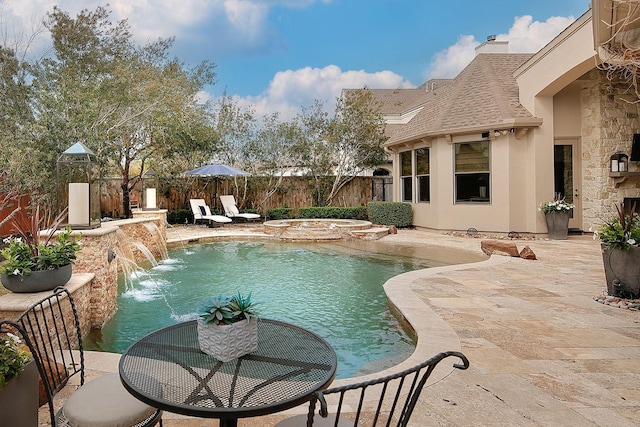 view of swimming pool with an in ground hot tub, a fenced backyard, a fenced in pool, and a patio area