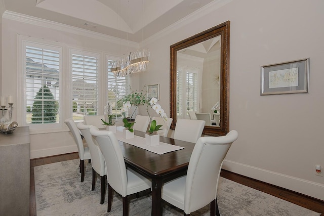 dining space with baseboards, plenty of natural light, and wood finished floors