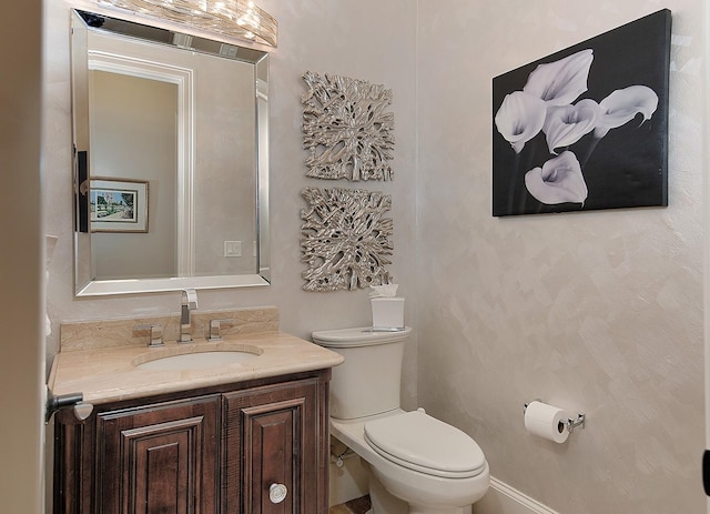 bathroom with toilet and vanity