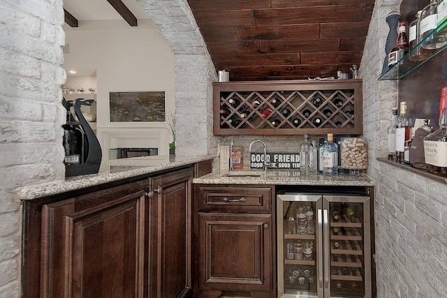 bar with wet bar, lofted ceiling with beams, a sink, wine cooler, and wooden ceiling