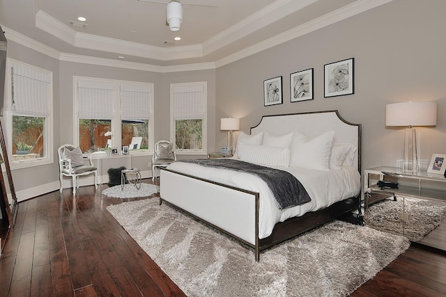 bedroom featuring visible vents, ornamental molding, a raised ceiling, and hardwood / wood-style flooring