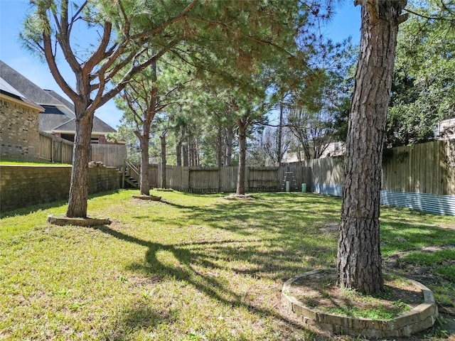 view of yard with a fenced backyard