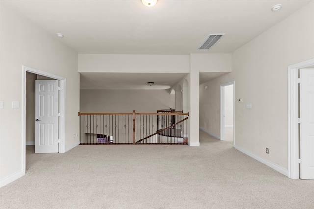 spare room with visible vents, baseboards, and carpet