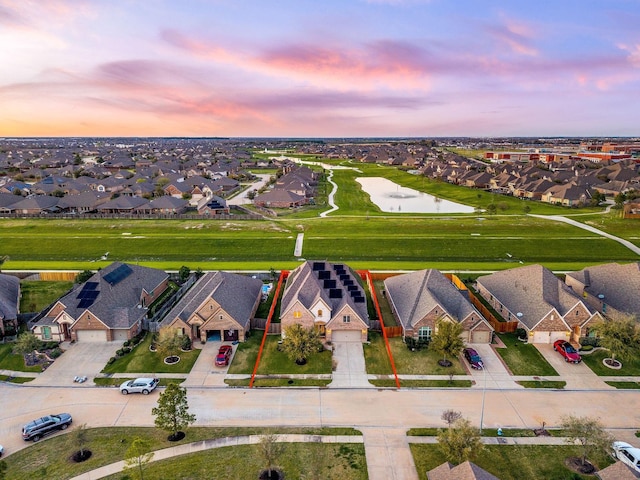 aerial view at dusk featuring a residential view