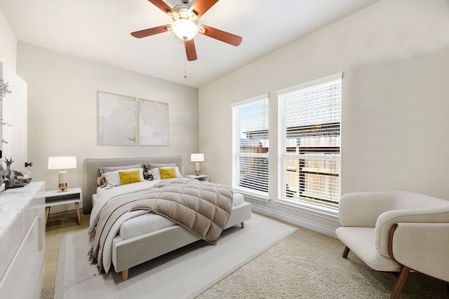 bedroom featuring light colored carpet and ceiling fan