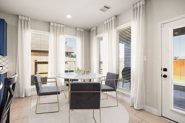 dining room with light tile patterned floors, baseboards, and visible vents