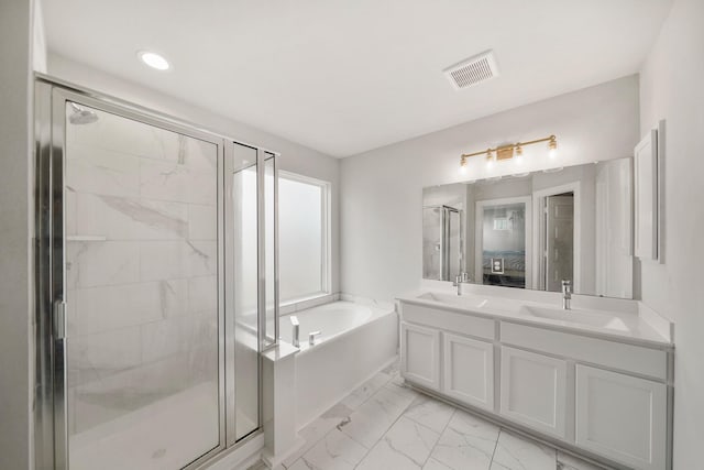 bathroom featuring a bath, visible vents, marble finish floor, and a sink