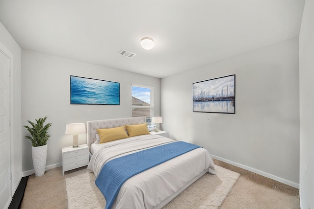 carpeted bedroom with baseboards and visible vents