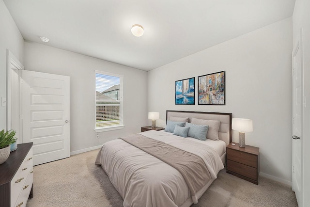 bedroom featuring baseboards and light colored carpet