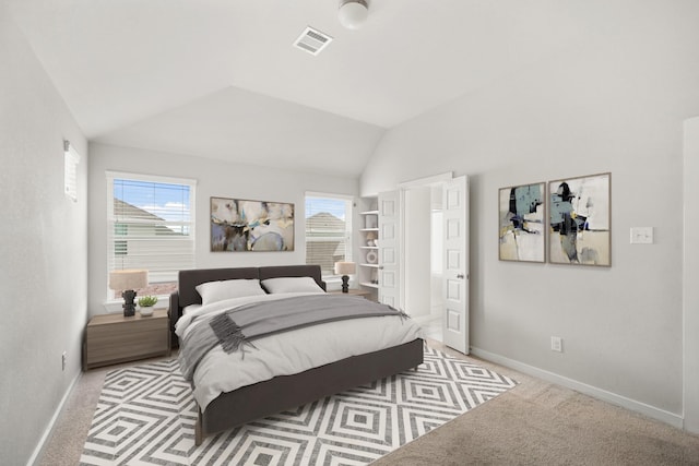 bedroom with visible vents, baseboards, lofted ceiling, and carpet