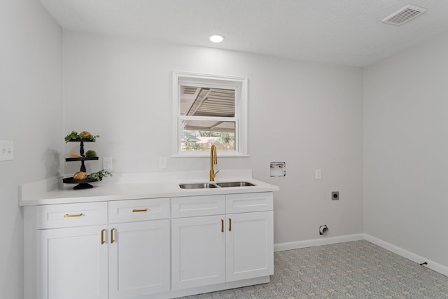 laundry area with visible vents, washer hookup, a sink, baseboards, and hookup for an electric dryer