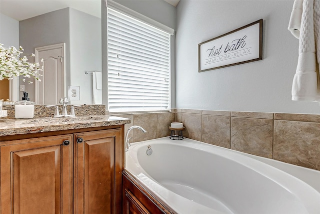 bathroom with a bath and vanity