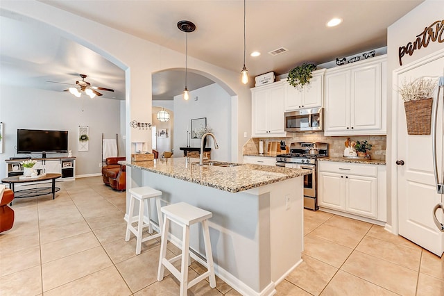 kitchen featuring a sink, stainless steel appliances, visible vents, and light tile patterned flooring