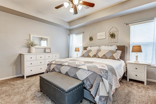 carpeted bedroom with multiple windows, baseboards, and ceiling fan