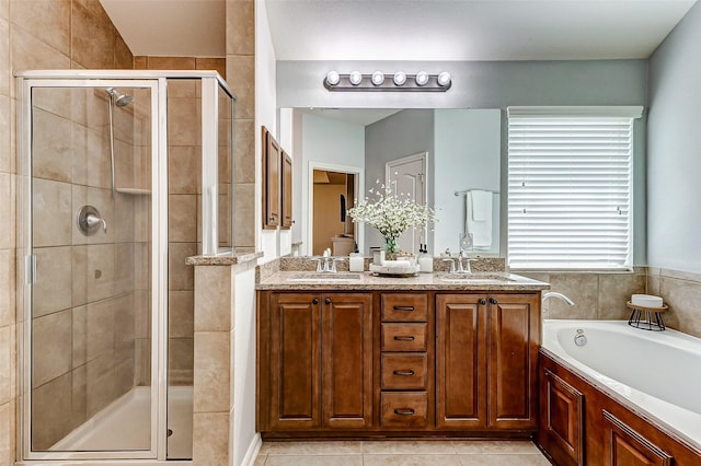 bathroom featuring a bath, a stall shower, double vanity, and a sink