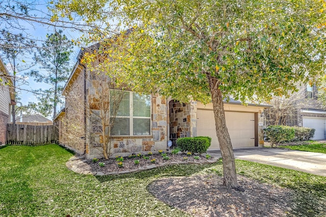 view of property hidden behind natural elements featuring a front lawn, driveway, stone siding, fence, and a garage