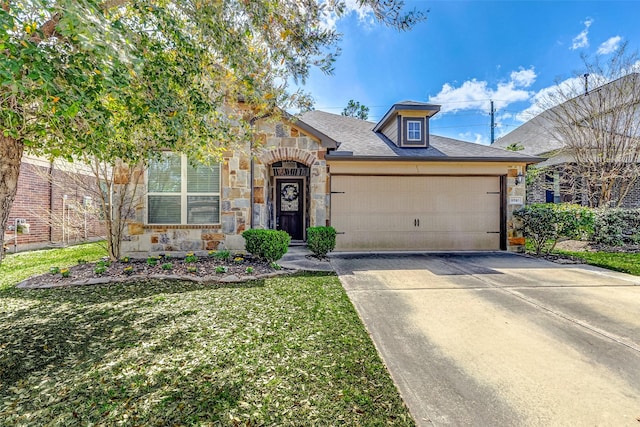 view of front of home with a front yard, driveway, an attached garage, a shingled roof, and stone siding