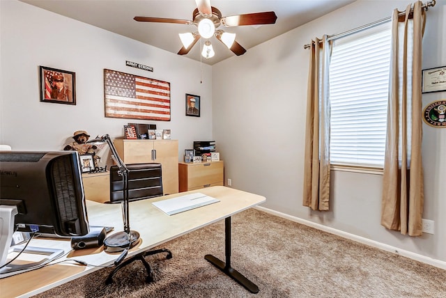 home office featuring carpet flooring, a ceiling fan, baseboards, and a wealth of natural light