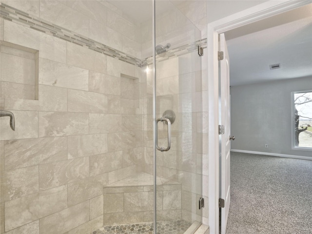 full bathroom with baseboards, a shower stall, and visible vents