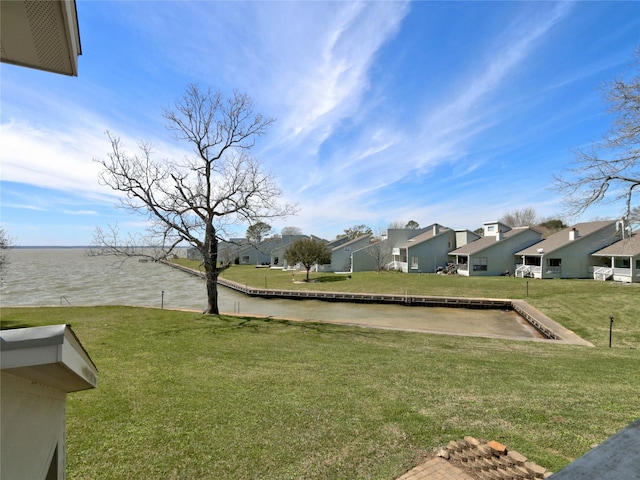 view of yard featuring a water view and a residential view