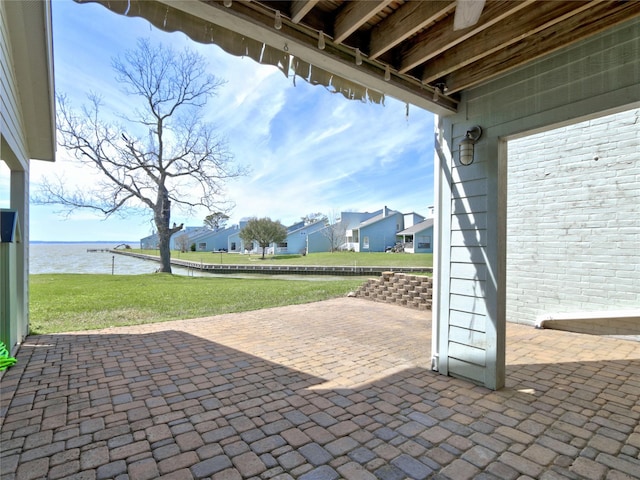 view of patio featuring a water view and a residential view