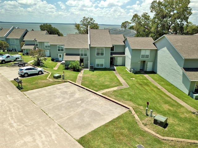 birds eye view of property featuring a water view and a residential view