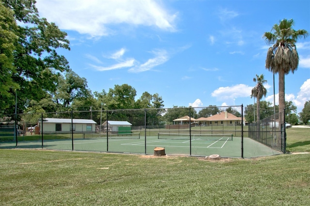 view of sport court featuring a yard and fence