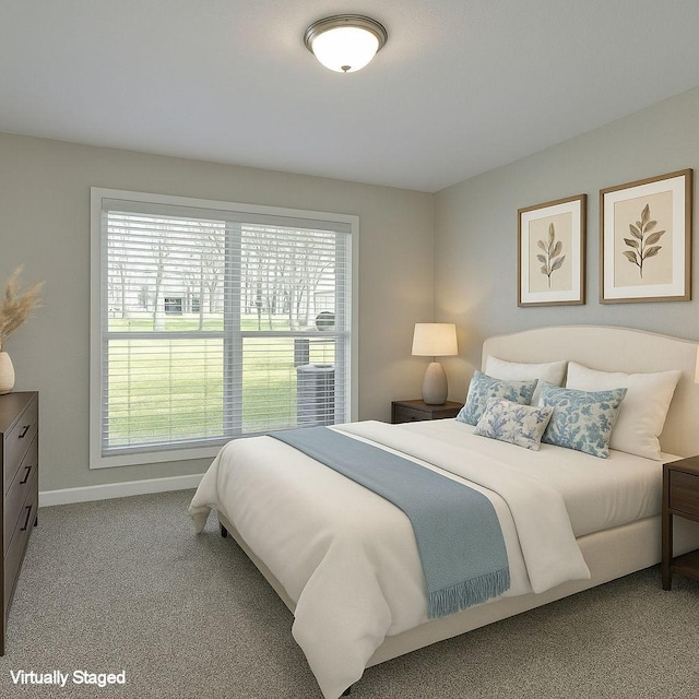carpeted bedroom with baseboards and multiple windows