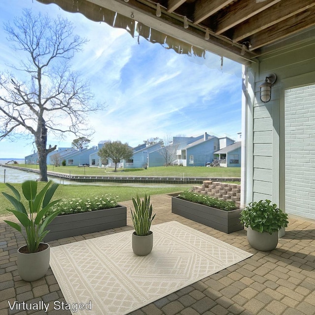 view of patio / terrace with a water view and a residential view