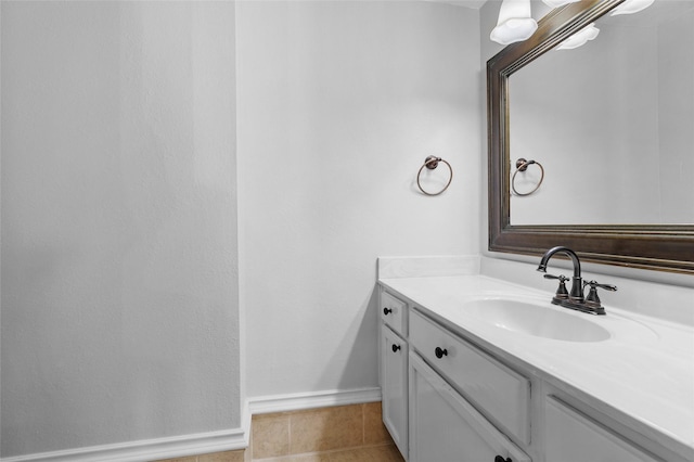 bathroom with tile patterned flooring, vanity, and baseboards